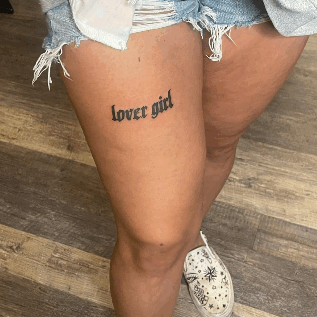 Lover girl script tattoo on thigh